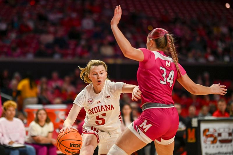 Jan 31, 2024; College Park, Maryland, USA;  Indiana Hoosiers guard Lenee Beaumont (5) dribbles as Maryland Terrapins guard Emily Fisher (34) defends during the first half  at Xfinity Center. Mandatory Credit: Tommy Gilligan-USA TODAY Sports