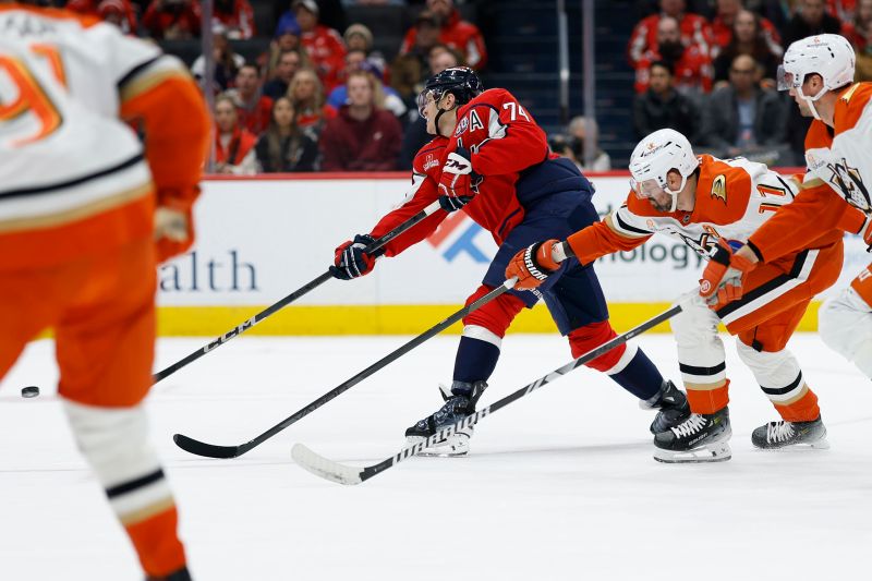 Jan 14, 2025; Washington, District of Columbia, USA; Washington Capitals defenseman John Carlson (74) scores a goal as Anaheim Ducks right wing Frank Vatrano (77) defends in the first period at Capital One Arena. Mandatory Credit: Geoff Burke-Imagn Images