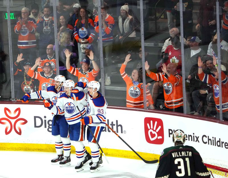 Feb 19, 2024; Tempe, Arizona, USA; Edmonton Oilers left wing Zach Hyman (18) celebrates his goal with Edmonton Oilers center Connor McDavid (97) and Edmonton Oilers center Ryan Nugent-Hopkins (93) against the Arizona Coyotes  during the third period at Mullett Arena. Mandatory Credit: Joe Camporeale-USA TODAY Sports