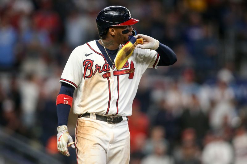 Oct 12, 2022; Atlanta, Georgia, USA; Atlanta Braves right fielder Ronald Acuna Jr. (13) reacts as he walks to first after being hit by a pitch in the game against the Philadelphia Phillies in the sixth inning during game two of the NLDS for the 2022 MLB Playoffs at Truist Park. Mandatory Credit: Brett Davis-USA TODAY Sports