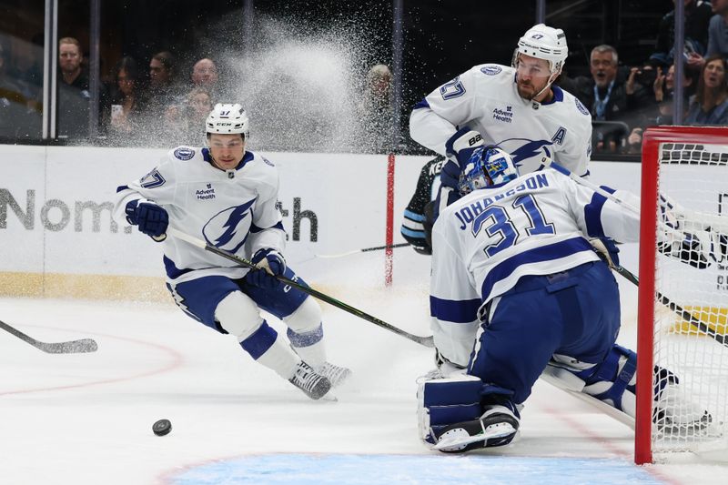Nov 2, 2025; Salt Lake City, Utah, USA; Tampa Bay Lightning center Yanni Gourde (37), Tampa Bay Lightning defenseman Ryan McDonagh (27) and Tampa Bay Lightning goaltender Jonas Johansson (31) clear the puck against the Utah Mammoth during the first period at Delta Center. Mandatory Credit: Rob Gray-Imagn Images