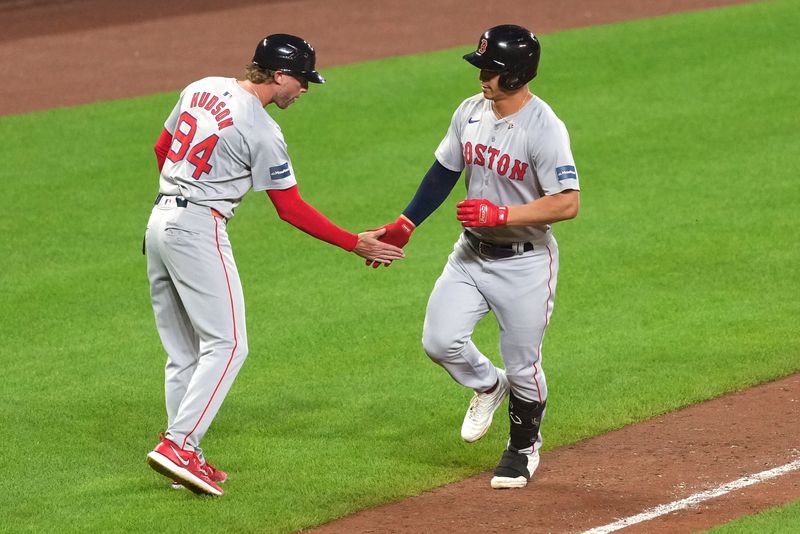 May 28, 2024; Baltimore, Maryland, USA; Boston Red Sox outfielder Rob Refsnyder (30) greeted by coach Kyle Hudson (84) following his three run home run in the ninth inning against the Baltimore Orioles at Oriole Park at Camden Yards. Mandatory Credit: Mitch Stringer-USA TODAY Sports