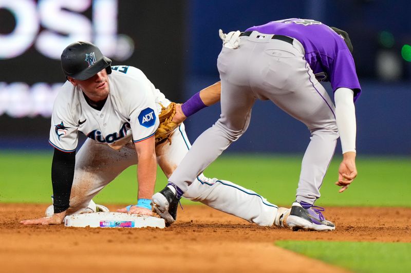 Jul 23, 2023; Miami, Florida, USA; Miami Marlins catcher Nick Fortes (4) steals second base against the Colorado Rockies during the sixth inning at loanDepot Park. Mandatory Credit: Rich Storry-USA TODAY Sports