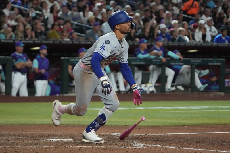 May 11, 2025; Phoenix, Arizona, USA; Los Angeles Dodgers shortstop Mookie Betts (50) hits a solo home run against the Arizona Diamondbacks in the ninth inning at Chase Field. Mandatory Credit: Rick Scuteri-Imagn Images