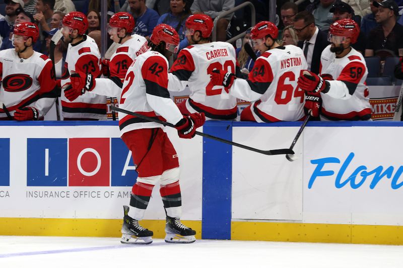 Sep 26, 2025; Tampa, Florida, USA; Carolina Hurricanes right wing Givani Smith (42) is congratulated after he scored a goal against the Tampa Bay Lightning during the first period at Benchmark International Arena. Mandatory Credit: Kim Klement Neitzel-Imagn Images