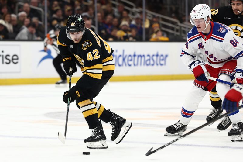 Nov 28, 2025; Boston, Massachusetts, USA; Boston Bruins center Georgii Merkulov (42) carries the puck against the New York Rangers during the first period at TD Garden. Mandatory Credit: Winslow Townson-Imagn Images