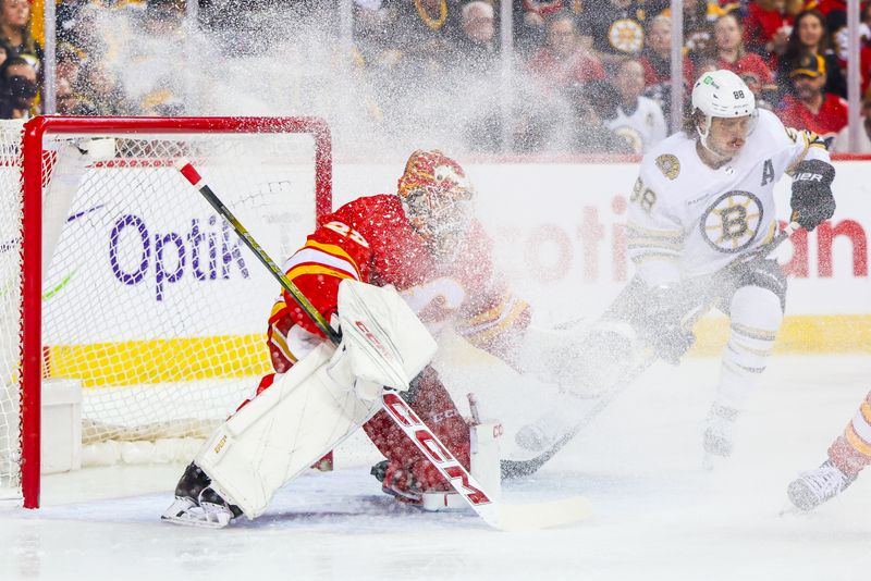 Feb 22, 2024; Calgary, Alberta, CAN; Calgary Flames goaltender Jacob Markstrom (25) guards his net against Boston Bruins right wing David Pastrnak (88) during the first period at Scotiabank Saddledome. Mandatory Credit: Sergei Belski-USA TODAY Sports