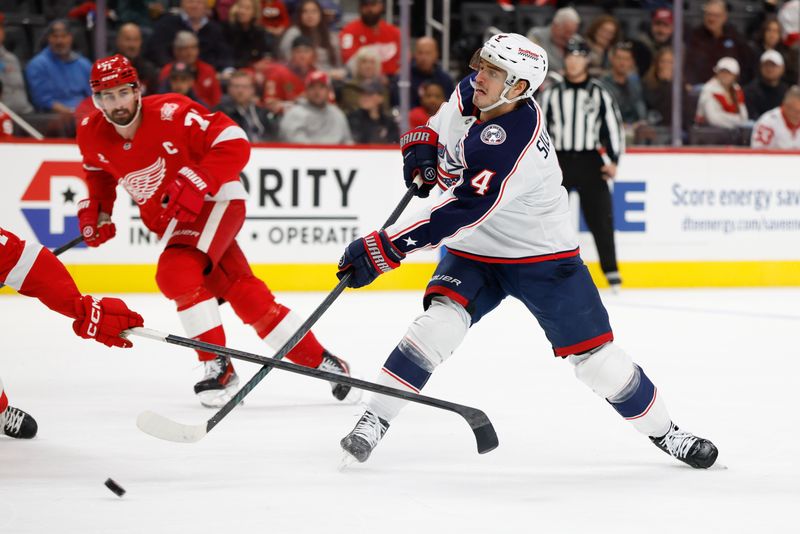 Nov 22, 2025; Detroit, Michigan, USA;  Columbus Blue Jackets center Cole Sillinger (4) takes a shot in the first period against the Detroit Red Wings at Little Caesars Arena. Mandatory Credit: Rick Osentoski-Imagn Images