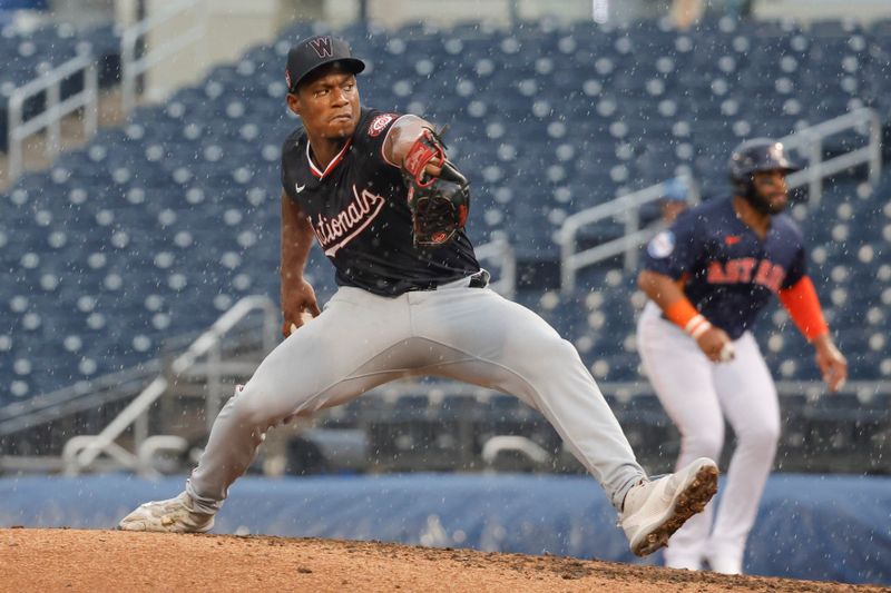 Mar 18, 2024; West Palm Beach, Florida, USA;  Washington Nationals starting pitcher Josiah Gray (40) throws a pitch in the rain during the fourth  inning against the Houston Astros at The Ballpark of the Palm Beaches. Mandatory Credit: Reinhold Matay-USA TODAY Sports