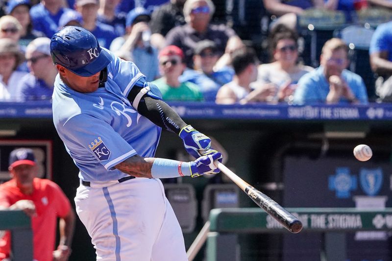 May 27, 2023; Kansas City, Missouri, USA; Kansas City Royals catcher Salvador Perez (13) hits a solo home run against the Washington Nationals in the third inning at Kauffman Stadium. Mandatory Credit: Denny Medley-USA TODAY Sports