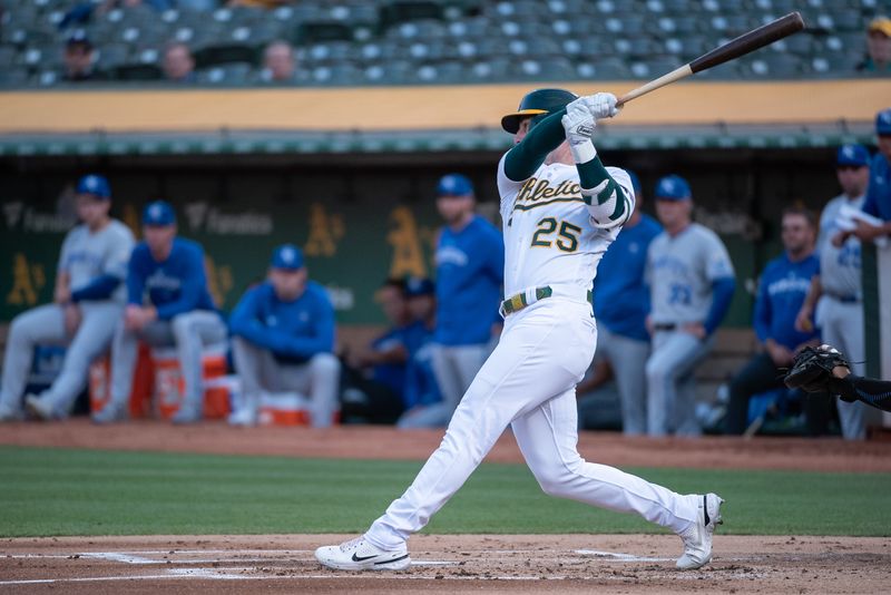 Aug 22, 2023; Oakland, California, USA; Oakland Athletics left fielder Brent Rooker (25) hits an RBI single during the first inning against the Kansas City Royals at Oakland-Alameda County Coliseum. Mandatory Credit: Ed Szczepanski-USA TODAY Sports