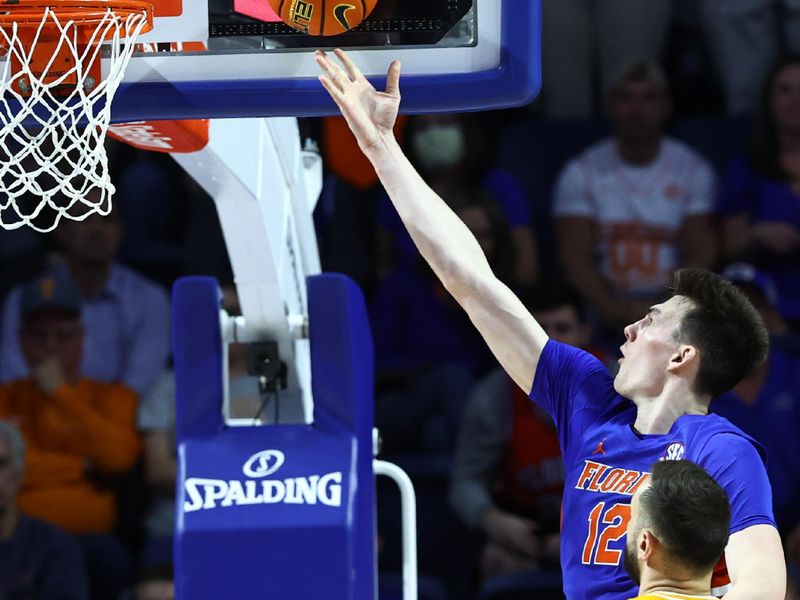 Feb 1, 2023; Gainesville, Florida, USA; Florida Gators forward Colin Castleton (12) shoots over Tennessee Volunteers forward Uros Plavsic (33) during the second half at Exactech Arena at the Stephen C. O'Connell Center. Mandatory Credit: Kim Klement-USA TODAY Sports