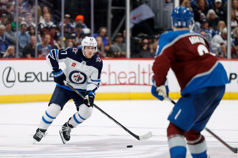 Apr 26, 2024; Denver, Colorado, USA; Winnipeg Jets left wing Nikolaj Ehlers (27) controls the puck as Colorado Avalanche defenseman Cale Makar (8) defends in the third period in game three of the first round of the 2024 Stanley Cup Playoffs at Ball Arena. Mandatory Credit: Isaiah J. Downing-USA TODAY Sports