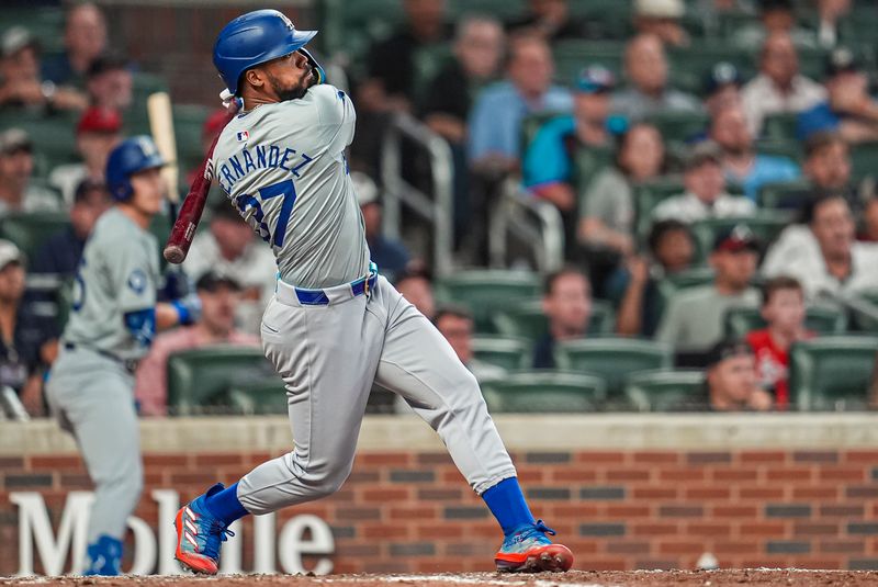 Sep 15, 2024; Cumberland, Georgia, USA; Los Angeles Dodgers left fielder Teoscar Hernandez (37) hits a two run home run against the Atlanta Braves during the ninth inning at Truist Park. Mandatory Credit: Dale Zanine-Imagn Images