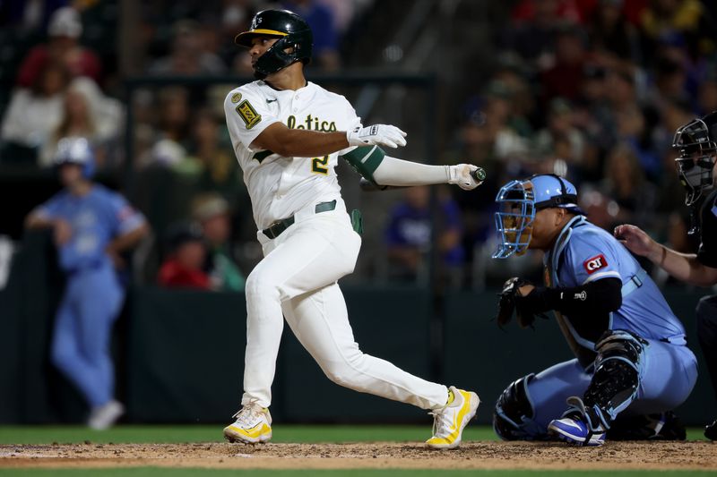 Sep 27, 2025; West Sacramento, California, USA; Athletics third baseman Darell Hernaiz (2) hits a single against the Kansas City Royals during the seventh inning at Sutter Health Park. Mandatory Credit: Dennis Lee-Imagn Images
