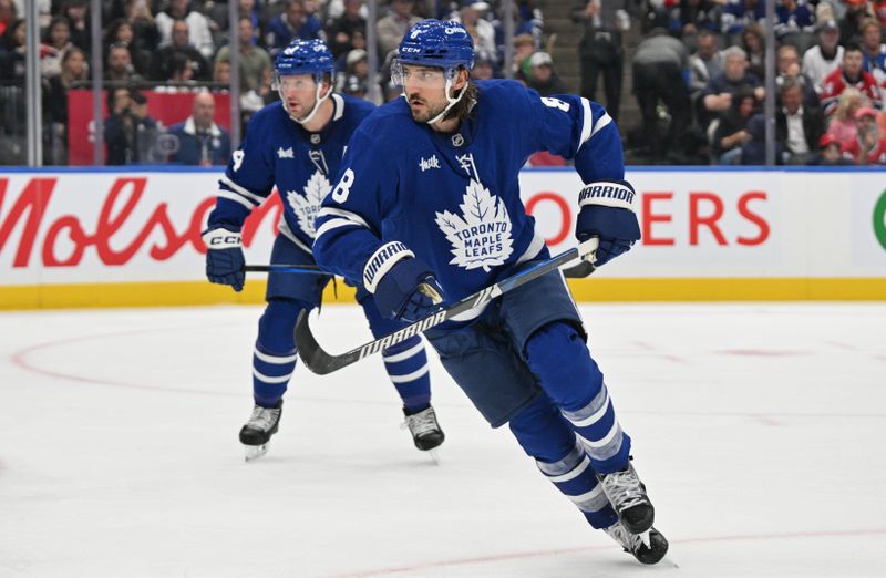 Sep 26, 2024; Toronto, Ontario, CAN;  Toronto Maple Leafs defenseman Chris Tanev (8) tracks the play as defenseman Morgan Rielly (44) looks on against the Montreal Canadiens in the second period at Scotiabank Arena. Mandatory Credit: Dan Hamilton-Imagn Images