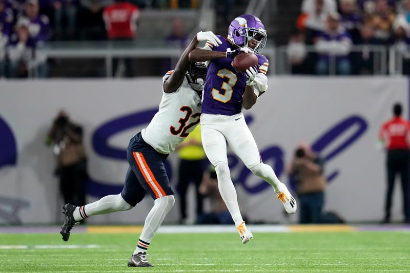 Minnesota Vikings wide receiver Jordan Addison (3) catches a pass over Chicago Bears cornerback Terell Smith (32) during the second half of an NFL football game, Monday, Nov. 27, 2023, in Minneapolis. (AP Photo/Abbie Parr)