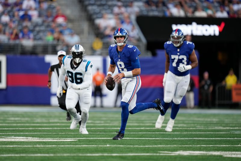 New York Giants quarterback Daniel Jones, center, looks to throw during the first half of an NFL preseason football game against the Carolina Panthers, Friday, Aug. 18, 2023, in East Rutherford, N.J. (AP Photo/Bryan Woolston)