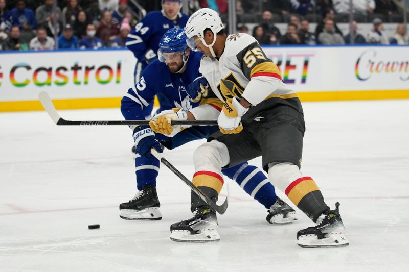 Nov 20, 2024; Toronto, Ontario, CAN; Toronto Maple Leafs defenceman Oliver Ekman-Larsson (95) and Vegas Golden Knights forward Keegan Kolesar (55) battle for the puck during the second period at Scotiabank Arena. Mandatory Credit: John E. Sokolowski-Imagn Images