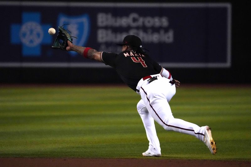 Aug 8, 2023; Phoenix, Arizona, USA; Arizona Diamondbacks second baseman Ketel Marte (4) fields a ground ball against the Los Angeles Dodgers during the eighth inning at Chase Field. Mandatory Credit: Joe Camporeale-USA TODAY Sports