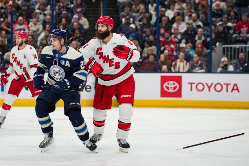 Nov 23, 2024; Columbus, Ohio, USA;  Carolina Hurricanes defenseman Brent Burns (8) reacts after losing his stick against Columbus Blue Jackets center Sean Monahan (23) in the second period at Nationwide Arena. Mandatory Credit: Aaron Doster-Imagn Images