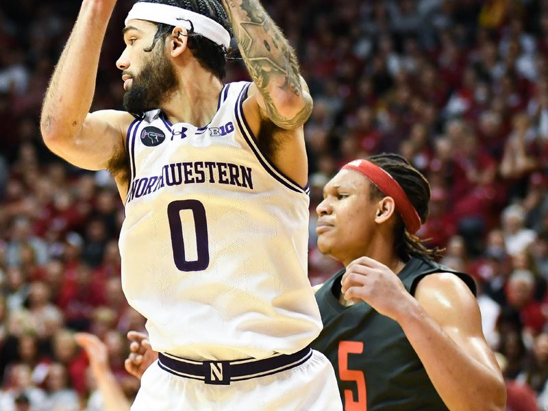 Feb 18, 2024; Bloomington, Indiana, USA;  Northwestern Wildcats guard Boo Buie (0) rebounds the ball in front of Indiana Hoosiers forward Malik Reneau (5) during the first half at Simon Skjodt Assembly Hall. Mandatory Credit: Robert Goddin-USA TODAY Sports