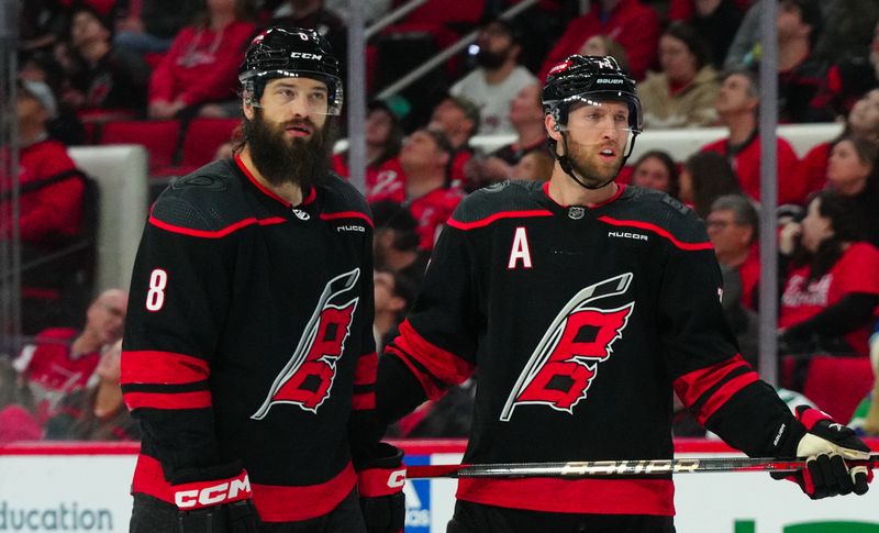 Apr 5, 2024; Raleigh, North Carolina, USA; Carolina Hurricanes defenseman Brent Burns (8) and defenseman Jaccob Slavin (74) look on against the Washington Capitals during the first period at PNC Arena. Mandatory Credit: James Guillory-USA TODAY Sports