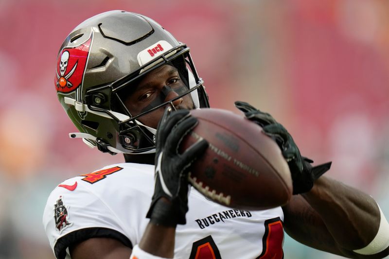 Tampa Bay Buccaneers wide receiver Chris Godwin (14) warms up before a pre season NFL football game against the Miami Dolphins, Friday, Aug. 23, 2024, in Tampa, Fla. (AP Photo/Chris O'Meara)