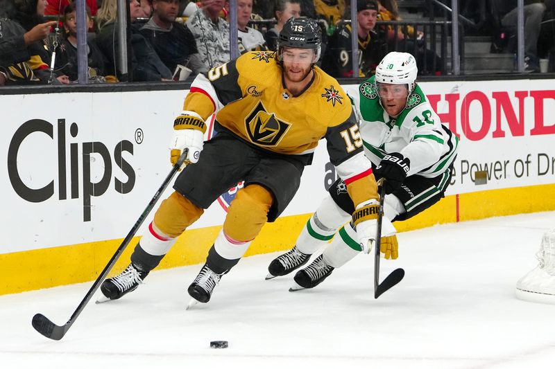 Apr 29, 2024; Las Vegas, Nevada, USA; Vegas Golden Knights defenseman Noah Hanafin (15) controls the puck ahead of Dallas Stars center Ty Dellandrea (10) during the second period of game four of the first round of the 2024 Stanley Cup Playoffs at T-Mobile Arena. Mandatory Credit: Stephen R. Sylvanie-USA TODAY Sports