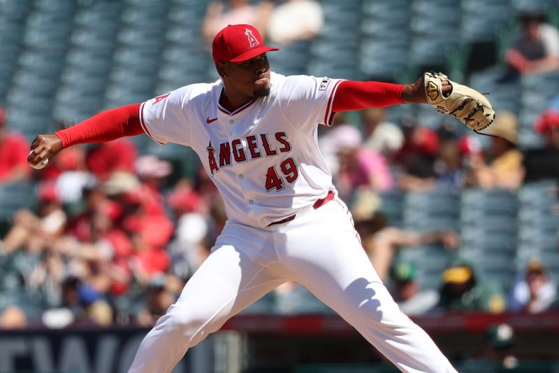 Jun 26, 2024; Anaheim, California, USA;  Los Angeles Angels relief pitcher Guillermo Zuniga (49) pitches during the eighth inning against the Oakland Athletics at Angel Stadium. Mandatory Credit: Kiyoshi Mio-USA TODAY Sports