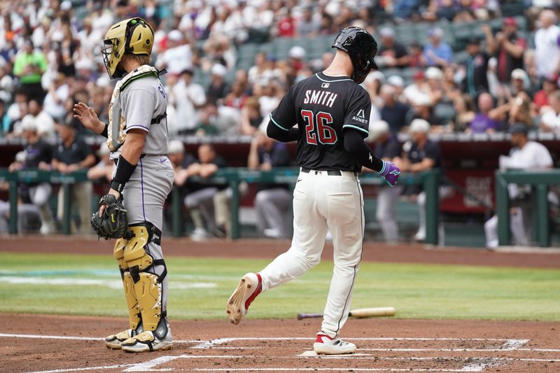 May 17, 2025; Phoenix, Arizona, USA; Arizona Diamondbacks first baseman Pavin Smith (26) scores a run against Colorado Rockies in the first inning at Chase Field. Mandatory Credit: Jacob Reiner-Imagn Images
