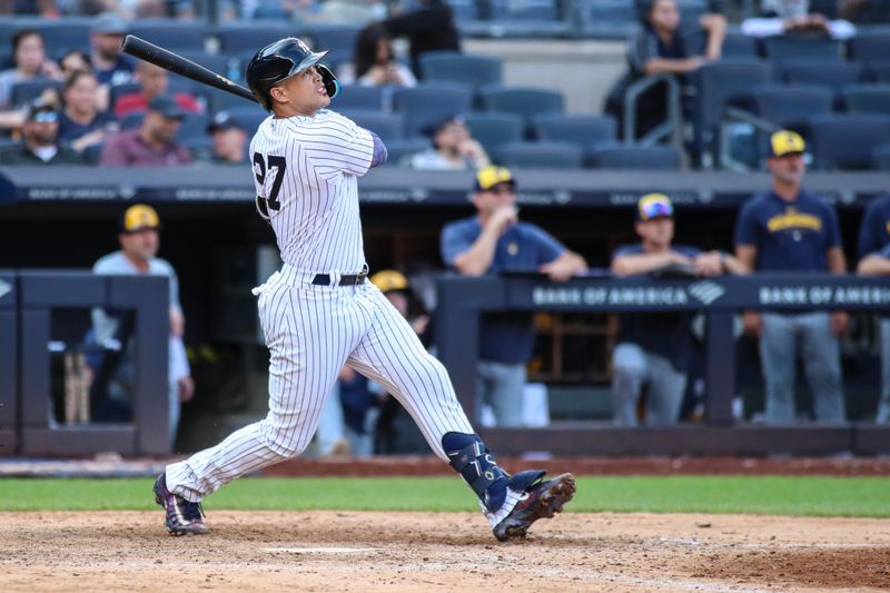 Sep 10, 2023; Bronx, New York, USA;  New York Yankees designated hitter Giancarlo Stanton (27) hits a two run home run to tie the game in the twelfth inning against the Milwaukee Brewers at Yankee Stadium. Mandatory Credit: Wendell Cruz-USA TODAY Sports