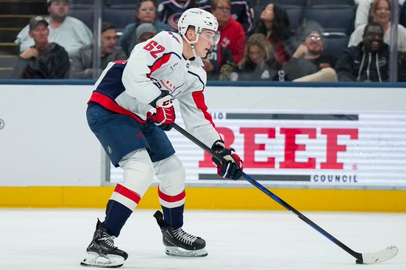 Sep 30, 2025; Columbus, Ohio, USA; Washington Capitals forward Ilya Protas (62) skates with the puck against the Columbus Blue Jackets in the second period at Nationwide Arena. Mandatory Credit: Aaron Doster-Imagn Images