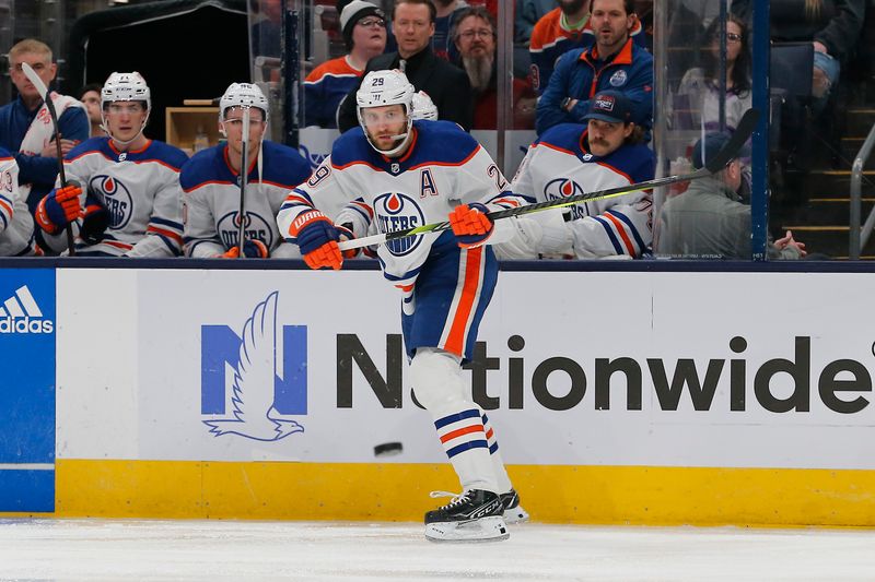 Mar 7, 2024; Columbus, Ohio, USA; Edmonton Oilers center Leon Draisaitl (29) passes the puck against the Columbus Blue Jackets during the second period at Nationwide Arena. Mandatory Credit: Russell LaBounty-USA TODAY Sports