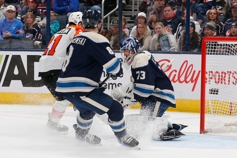 Apr 6, 2024; Columbus, Ohio, USA; Columbus Blue Jackets goalie Jet Greaves (73) makes a save as Philadelphia Flyers center Scott Laughton (21) looks for a rebound during the second period at Nationwide Arena. Mandatory Credit: Russell LaBounty-USA TODAY Sports