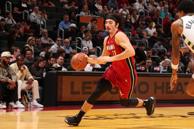 MIAMI, FL - NOVEMBER 26: Jaime Jaquez Jr. #11 of the Miami Heat drives to the basket during the game against the Milwaukee Bucks during the Emirates NBA Cup game on November 26, 2024 at Kaseya Center in Miami, Florida. NOTE TO USER: User expressly acknowledges and agrees that, by downloading and or using this Photograph, user is consenting to the terms and conditions of the Getty Images License Agreement. Mandatory Copyright Notice: Copyright 2024 NBAE (Photo by Issac Baldizon/NBAE via Getty Images)