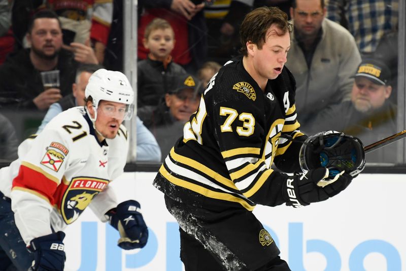 Apr 6, 2024; Boston, Massachusetts, USA; Boston Bruins defenseman Charlie McAvoy (73) has his helmet knocked off by Florida Panthers center Nick Cousins (21) during the second period at TD Garden. Mandatory Credit: Bob DeChiara-USA TODAY Sports