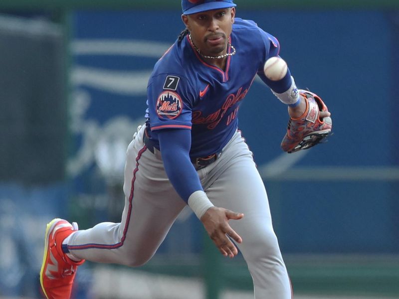 Jun 28, 2025; Pittsburgh, Pennsylvania, USA;  New York Mets shortstop Francisco Lindor (12) flips the ball to second baseman Brett Baty (not pictured) for a force-out at second base to end the first inning against the Pittsburgh Pirates at PNC Park. Mandatory Credit: Charles LeClaire-Imagn Images