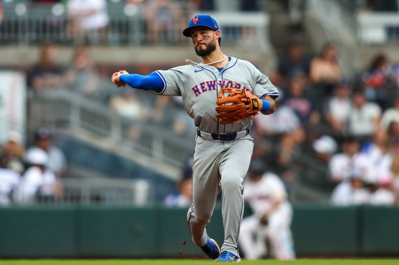 Sep 30, 2024; Atlanta, Georgia, USA; New York Mets shortstop Eddy Alvarez (26) throws a runner out at first against the Atlanta Braves in the fourth inning at Truist Park. Mandatory Credit: Brett Davis-Imagn Images