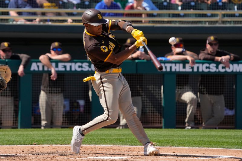 Mar 12, 2023; Mesa, Arizona, USA; San Diego Padres right fielder Jose Azocar (28) hits against the Oakland Athletics in the third inning at Hohokam Stadium. Mandatory Credit: Rick Scuteri-USA TODAY Sports