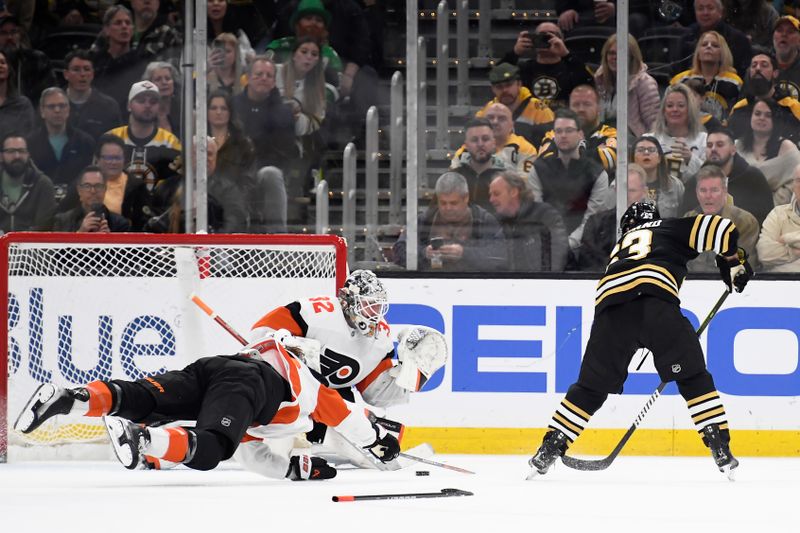 Mar 16, 2024; Boston, Massachusetts, USA; Boston Bruins left wing Brad Marchand (63) slides the puck over to center Charlie Coyle (13) (not pictured) past Philadelphia Flyers goaltender Felix Sandstrom (32) during the second period at TD Garden. Mandatory Credit: Bob DeChiara-USA TODAY Sports