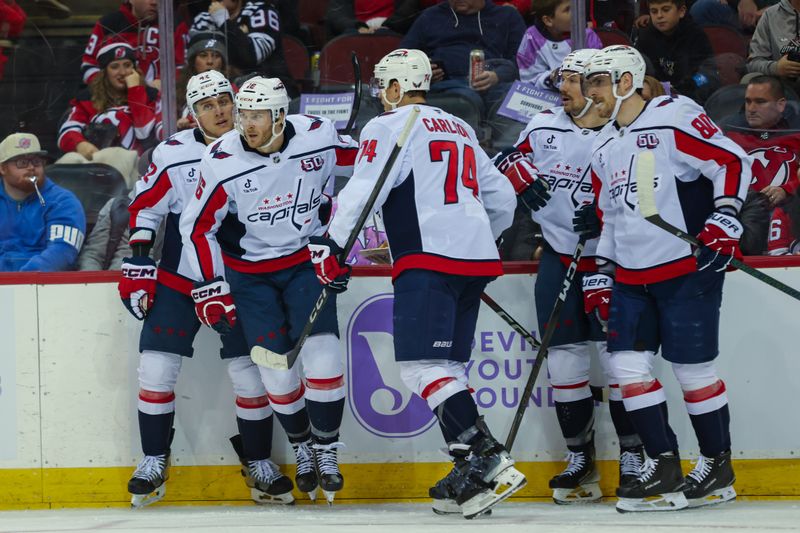 Nov 30, 2024; Newark, New Jersey, USA; Washington Capitals right wing Taylor Raddysh (16) celebrates his goal with his teammates against the New Jersey Devils during the third period at Prudential Center. Mandatory Credit: Thomas Salus-Imagn Images