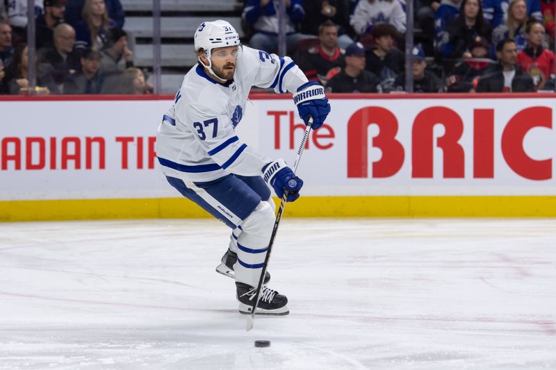 Feb 10, 2024; Ottawa, Ontario, CAN; Toronto Maple Leafs defenseman Timothy Liljegren (37) skates with the puck in the first period against the Ottawa Senators at the Canadian Tire Centre. Mandatory Credit: Marc DesRosiers-USA TODAY Sports