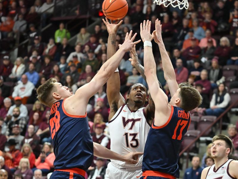 Dec 31, 2025; Blacksburg, Virginia, USA;   Virginia Tech Hokies forward Amani Hansberry (13) shoots a shot over Virginia Cavaliers center Johann Grünloh (17) and Virginia Cavaliers forward Thijs de Ridder (28) during the first half at Cassell Coliseum. Mandatory Credit: Brian Bishop-Imagn Images