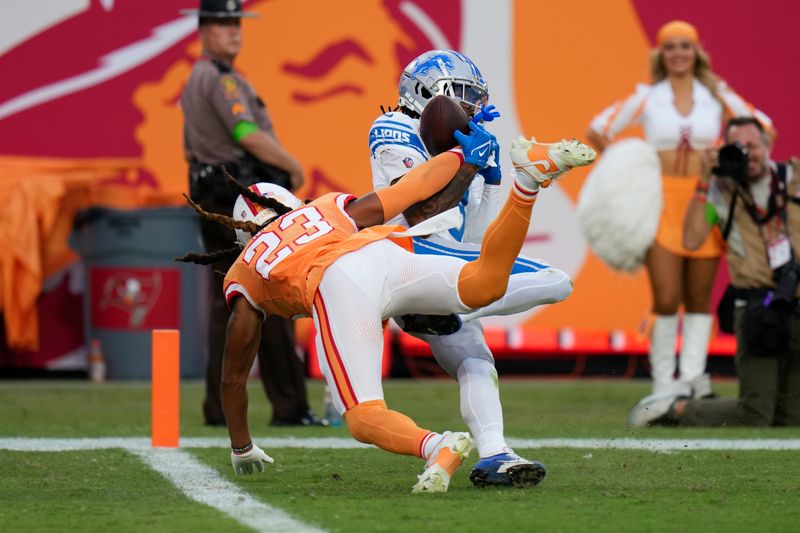 Detroit Lions wide receiver Jameson Williams (9) catches a 23-yard touchdown reception as Tampa Bay Buccaneers safety Ryan Neal (23) defends during the second half of an NFL football game Sunday, Oct. 15, 2023, in Tampa, Fla. (AP Photo/Chris O'Meara)