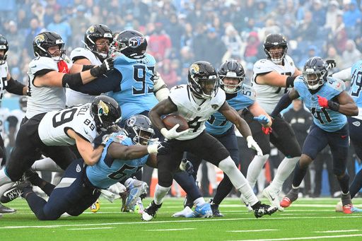 Jacksonville Jaguars running back Tank Bigsby (4) rushes against the Tennessee Titans in an NFL football game Monday, Dec. 9, 2024, in Nashville, Tenn. (AP Photo/John Amis)