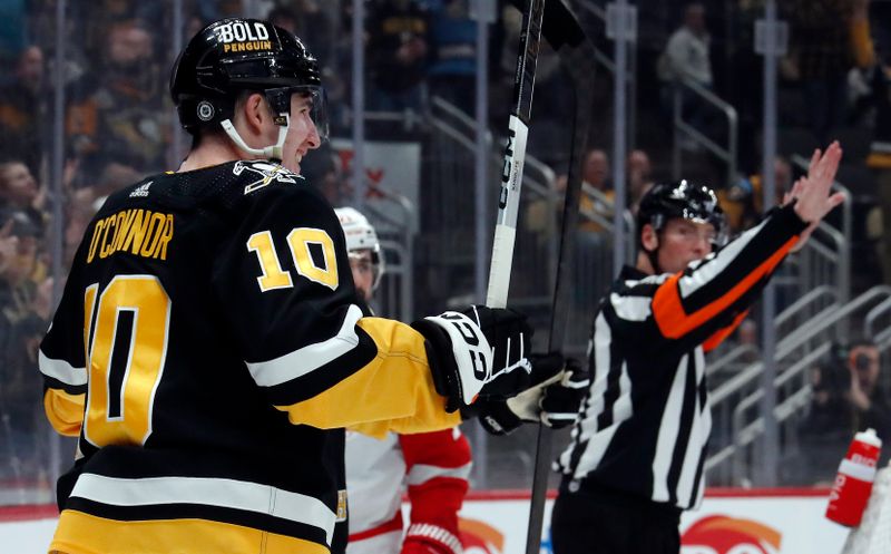 Apr 11, 2024; Pittsburgh, Pennsylvania, USA; Pittsburgh Penguins left wing Drew O'Connor (10) reacts after scoring a goal the Detroit Red Wings during the first period at PPG Paints Arena. Mandatory Credit: Charles LeClaire-USA TODAY Sports