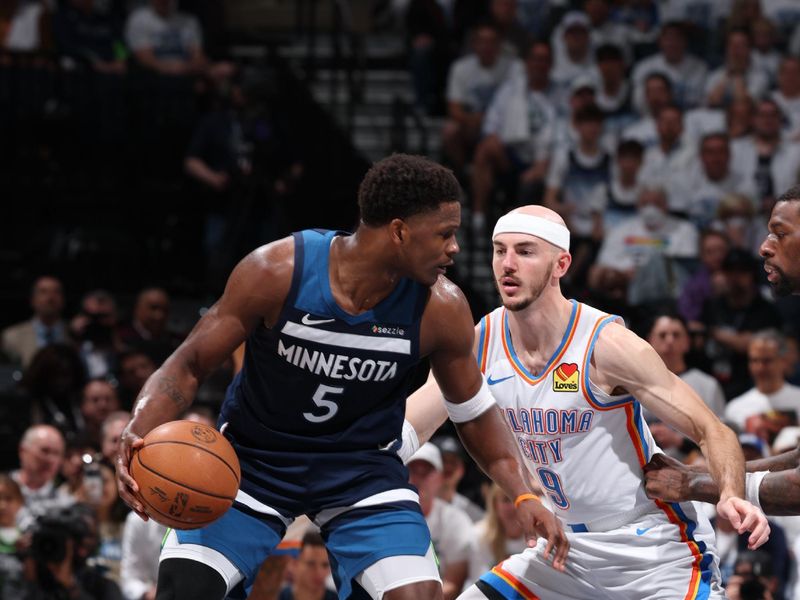 MINNEAPOLIS, MN - MAY 24: Anthony Edwards #5 of the Minnesota Timberwolves handles the ball while Alex Caruso #9 of the Oklahoma City Thunder plays defense during the game during Game Three of the Western Conference Finals on May 24, 2025 at Target Center in Minneapolis, Minnesota. NOTE TO USER: User expressly acknowledges and agrees that, by downloading and or using this Photograph, user is consenting to the terms and conditions of the Getty Images License Agreement. Mandatory Copyright Notice: Copyright 2025 NBAE (Photo by David Sherman/NBAE via Getty Images)