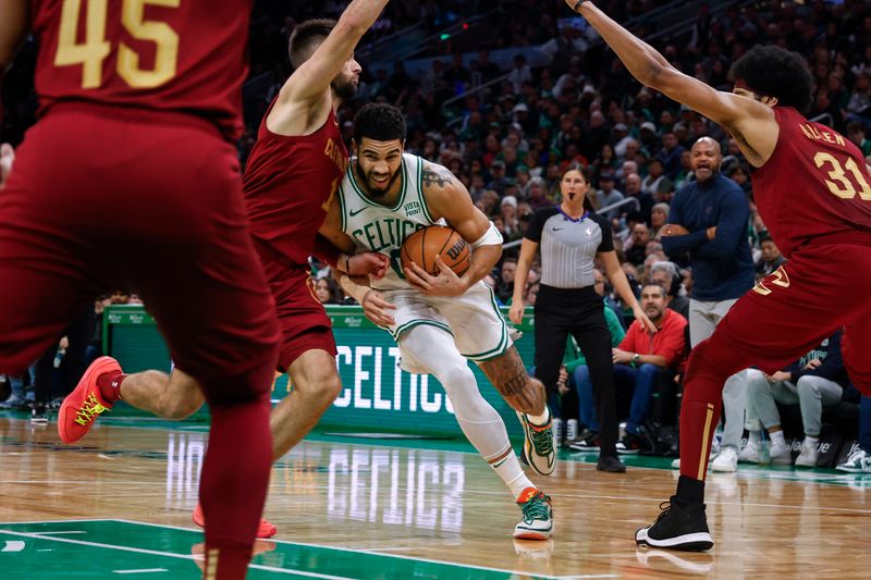 BOSTON, MA - DECEMBER 14: Jayson Tatum #0 of the Boston Celtics drives against Max Strus #1 of the Cleveland Cavaliers during the second half at TD Garden on December 14, 2023 in Boston, Massachusetts. NOTE TO USER: User expressly acknowledges and agrees that, by downloading and/or using this Photograph, user is consenting to the terms and conditions of the Getty Images License Agreement. (Photo By Winslow Townson/Getty Images)