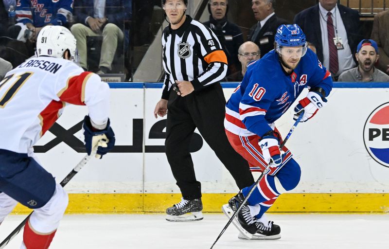 May 30, 2024; New York, New York, USA; New York Rangers left wing Artemi Panarin (10) skates with the puck as Florida Panthers defenseman Oliver Ekman-Larsson (91) defends during the first period in game five of the Eastern Conference Final of the 2024 Stanley Cup Playoffs at Madison Square Garden. Mandatory Credit: Dennis Schneidler-USA TODAY Sports